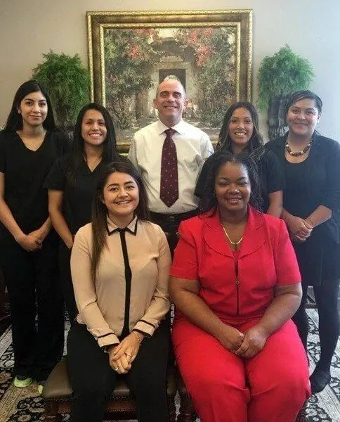 Dr. Javier Perez with members of the Times Square Family Dental team, gathered in the office.